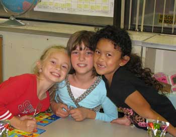 Three young girls smiling